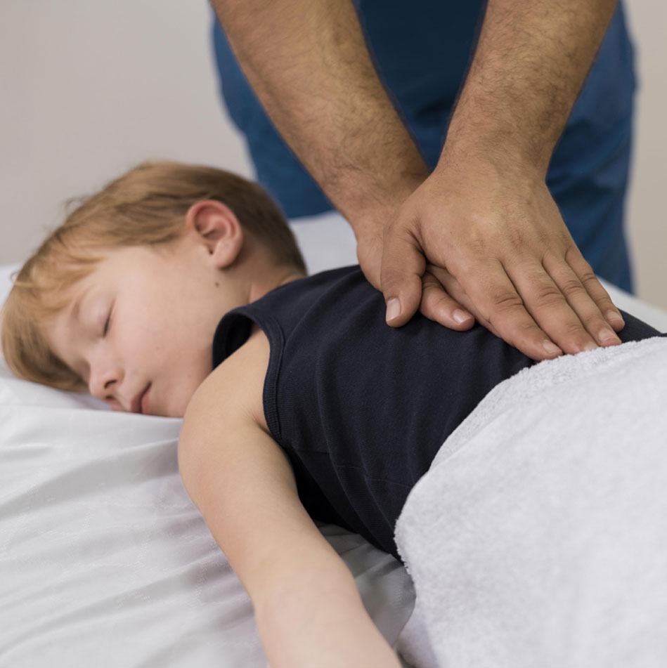 Chiropractor performing chiropractic treatment on a kid.