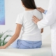 A woman receiving chiropractic care for poor posture problems.